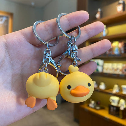 Cute creative key ring doll ornament, colorful miniature character keychain displayed on a plain background