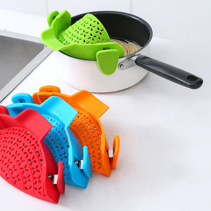 Silicone pot side drain stopper for kitchen gadgets, shown attached to a cooking pot rim