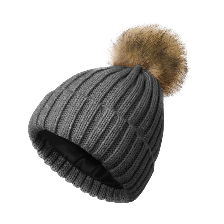 Women's solid-color brimmed hat with satin pom-pom detail, front view