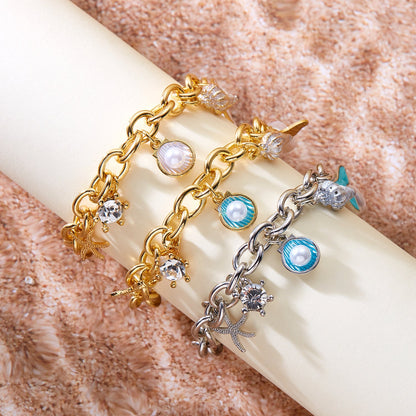 Women's starfish, pearl and shell multi-pendant fishtail necklace bracelet, close-up view