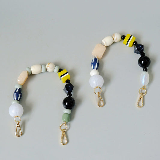 Colorful vintage handmade beaded bag chain accessory displayed against a plain background