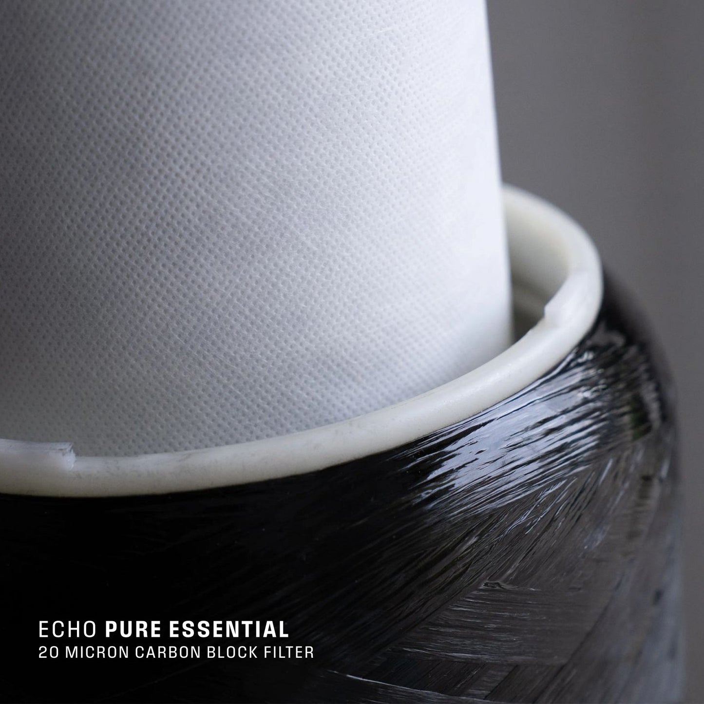 Close-up of Echo Water EchoPure1 whole home water filter unit with clear housing and filtration components visible.