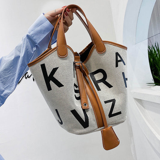 Women's letter printed canvas tote bag by BACKUPMYFILESNOW® with stylish design and durable handles, perfect for everyday use.
