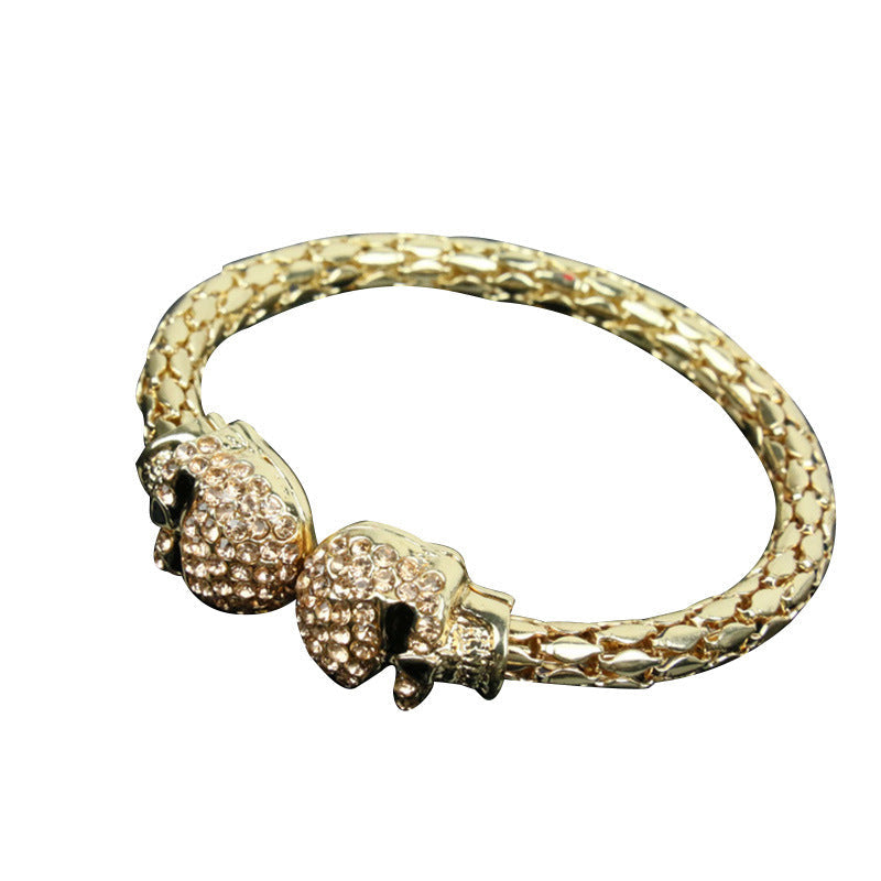 Golden skull open bangle studded with diamonds, shimmering light-luxury design
