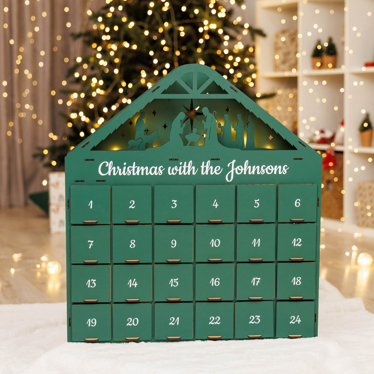 Green Christmas Advent Calendar by Enjoy The Wood, featuring numbered doors and holiday-themed design for counting down to Christmas.