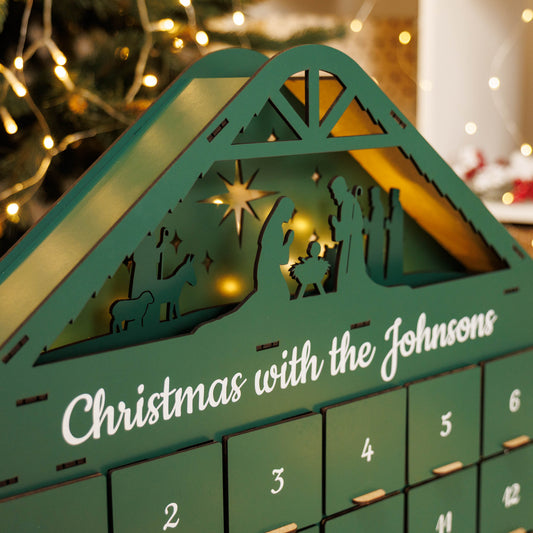 Green Christmas Advent Calendar by Enjoy The Wood, featuring numbered boxes for holiday countdown, made of wood with festive design.