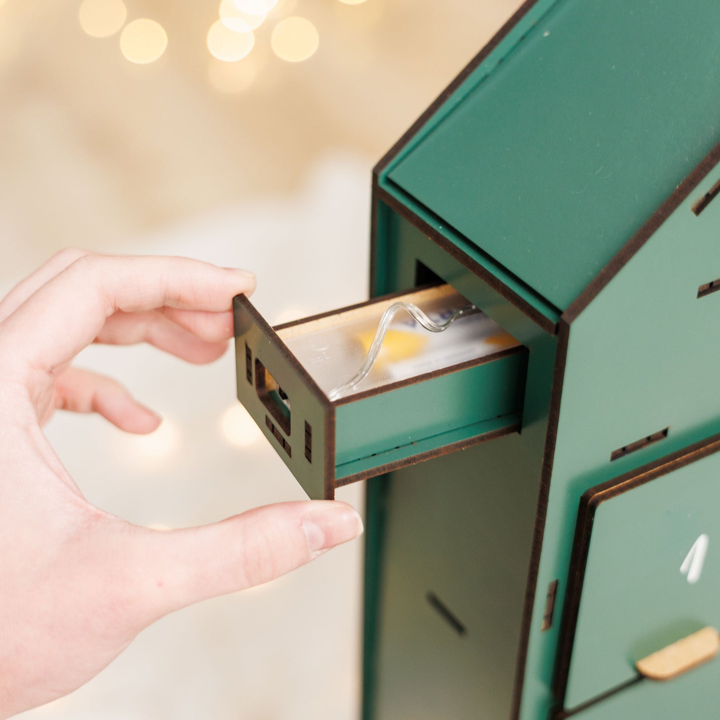 Green Enjoy The Wood Christmas Advent Calendar with numbered doors and festive holiday design.