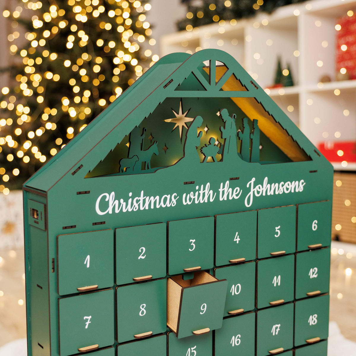 Green Christmas Advent Calendar by Enjoy The Wood, featuring numbered doors and festive holiday design for counting down to Christmas.