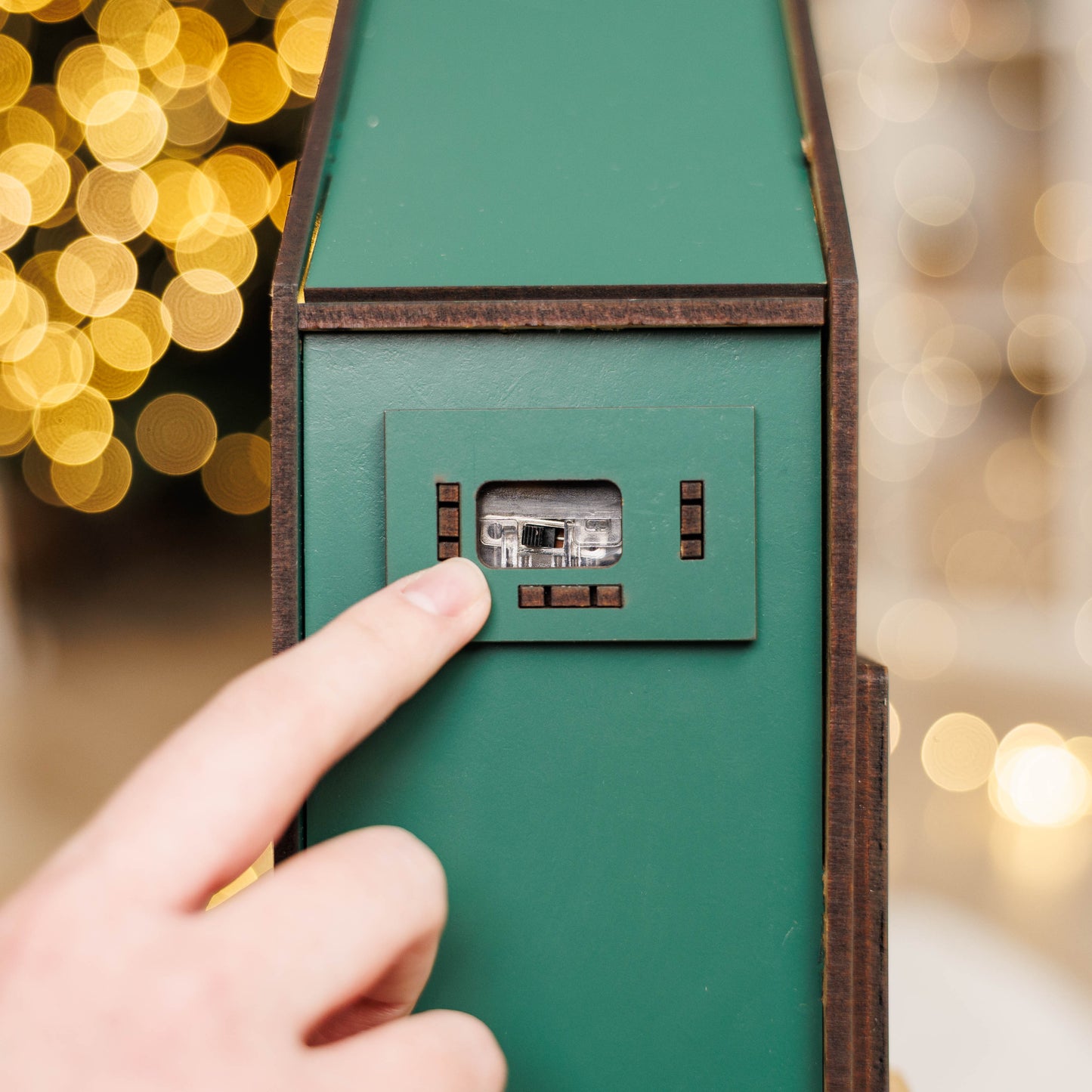 Green Christmas Advent Calendar by Enjoy The Wood featuring numbered doors and festive holiday design.