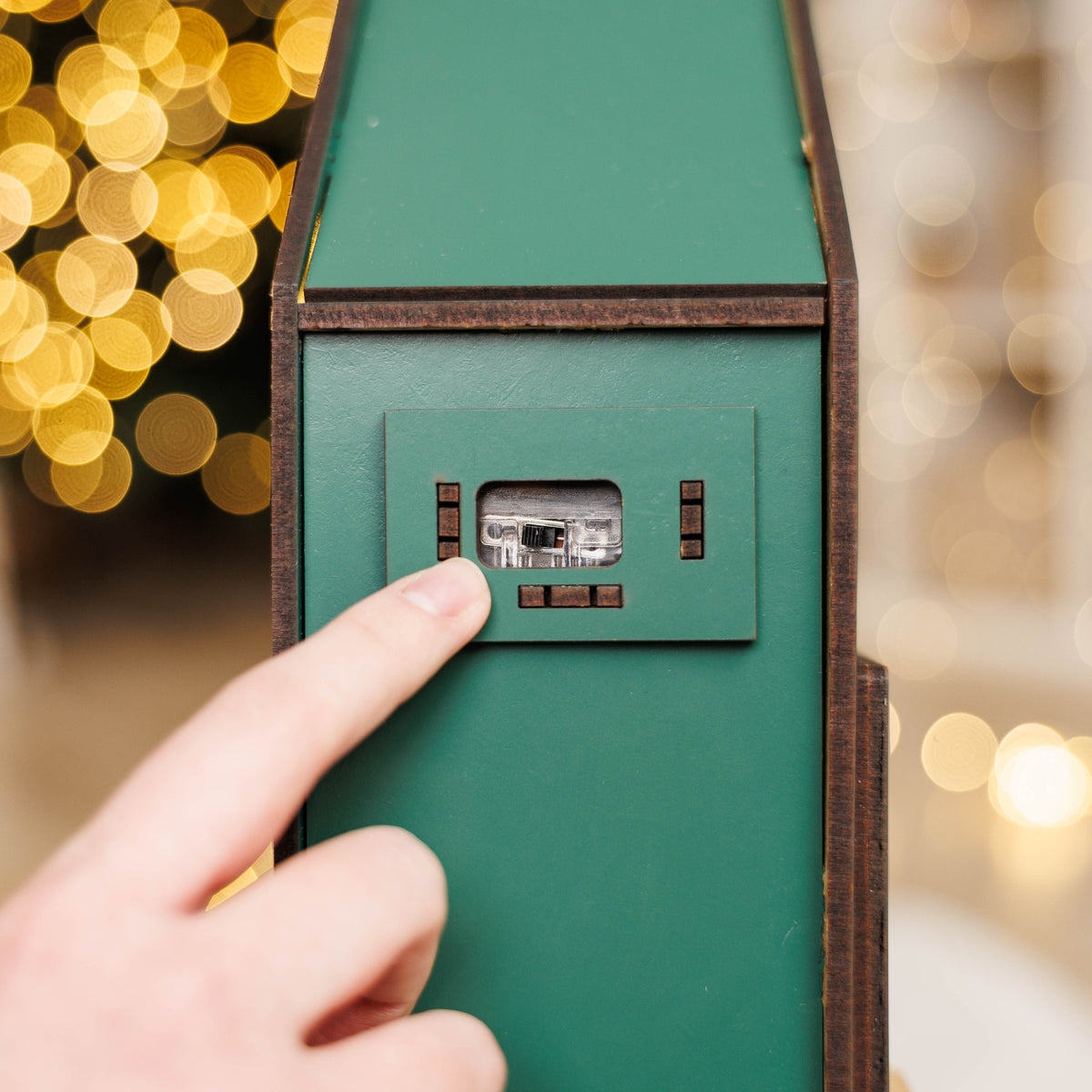 Green Christmas Advent Calendar by Enjoy The Wood featuring numbered doors and festive holiday design.