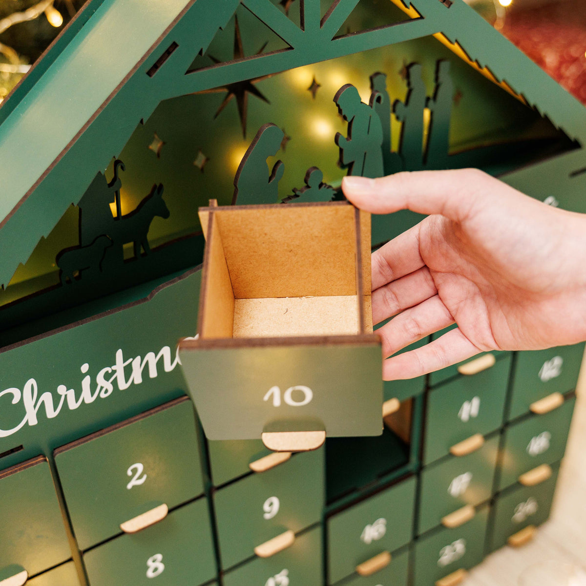 Green Christmas Advent Calendar by Enjoy The Wood with numbered doors and festive holiday design.