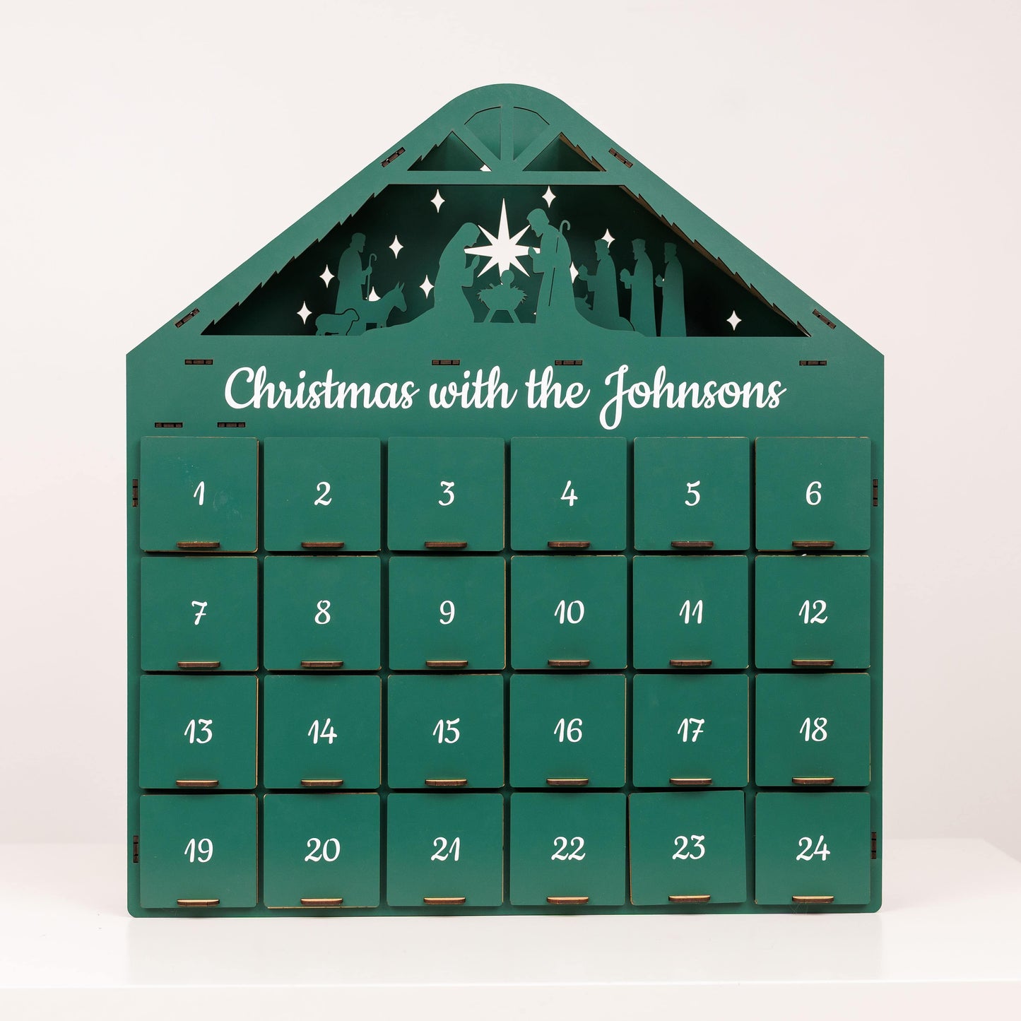 Green Christmas Advent Calendar by Enjoy The Wood featuring numbered doors and festive holiday design.