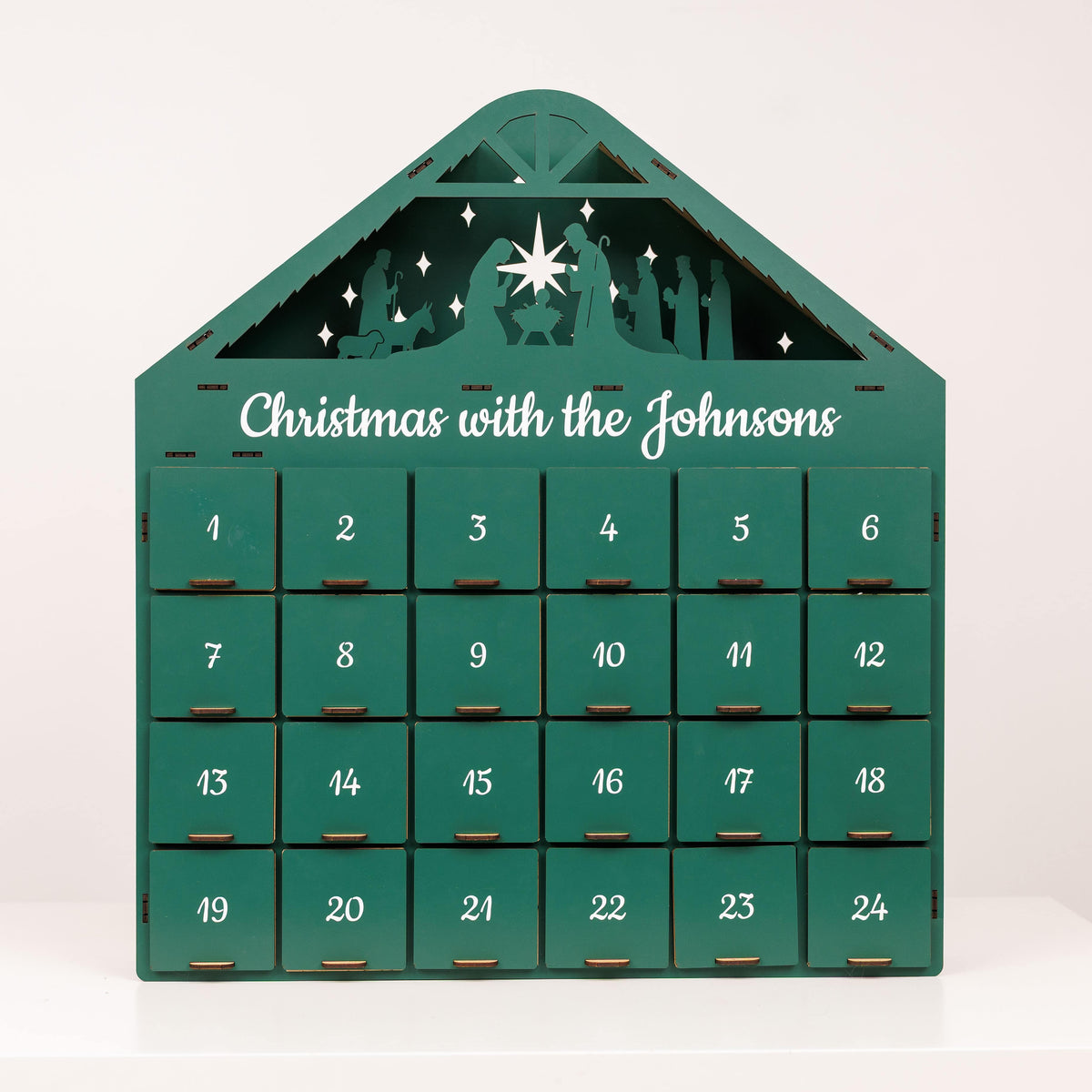 Green Christmas Advent Calendar by Enjoy The Wood featuring numbered doors and festive holiday design.