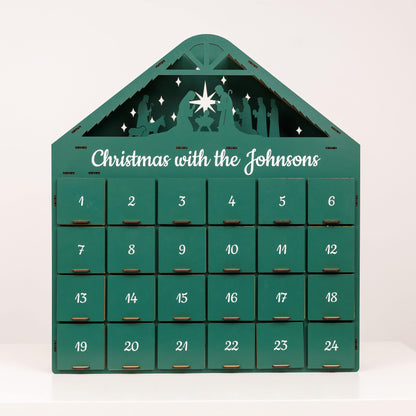 Green Christmas Advent Calendar by Enjoy The Wood featuring numbered doors and festive holiday design.