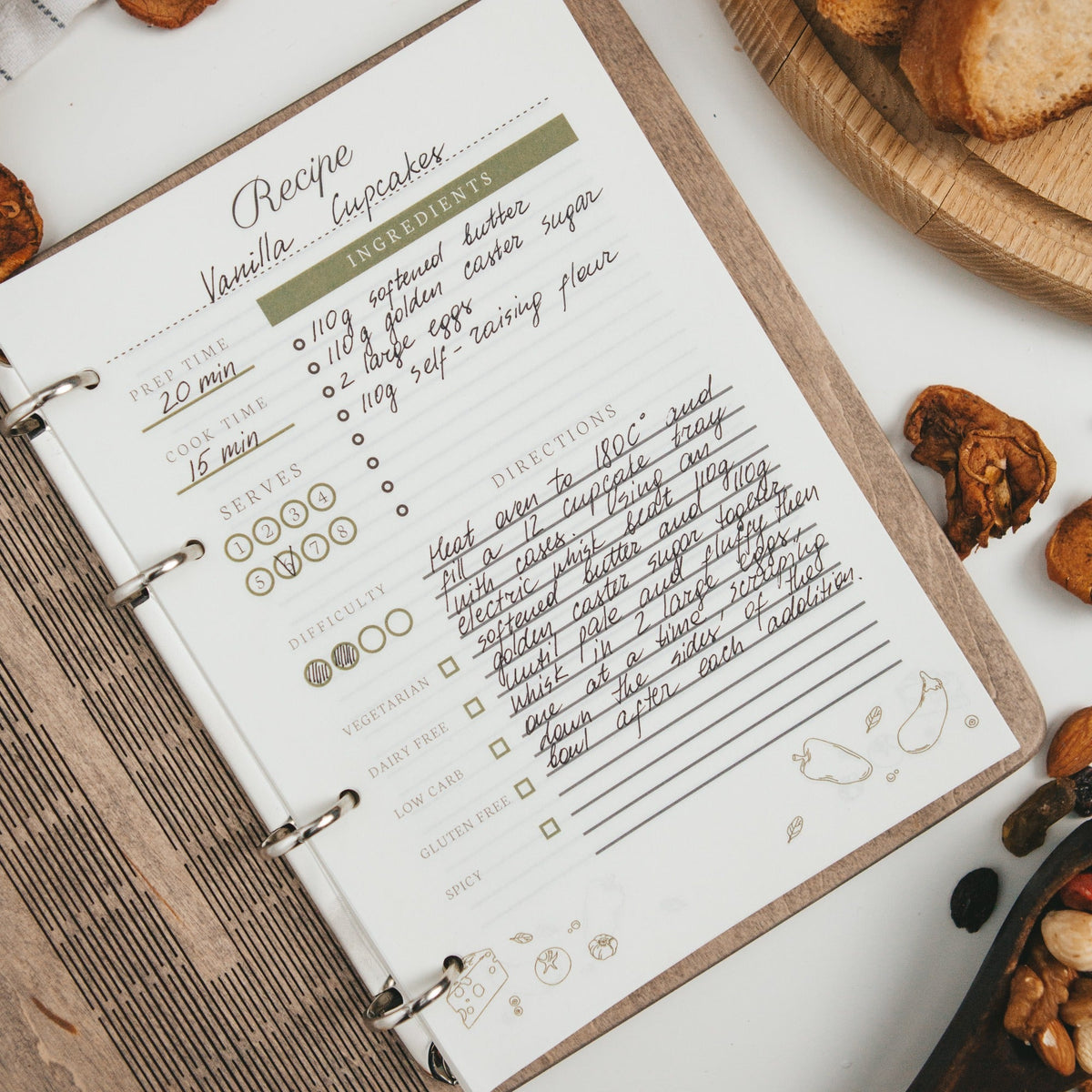 Enjoy The Wood recipe book basket with a cozy recipe book and decorative accents for kitchen organization and style.