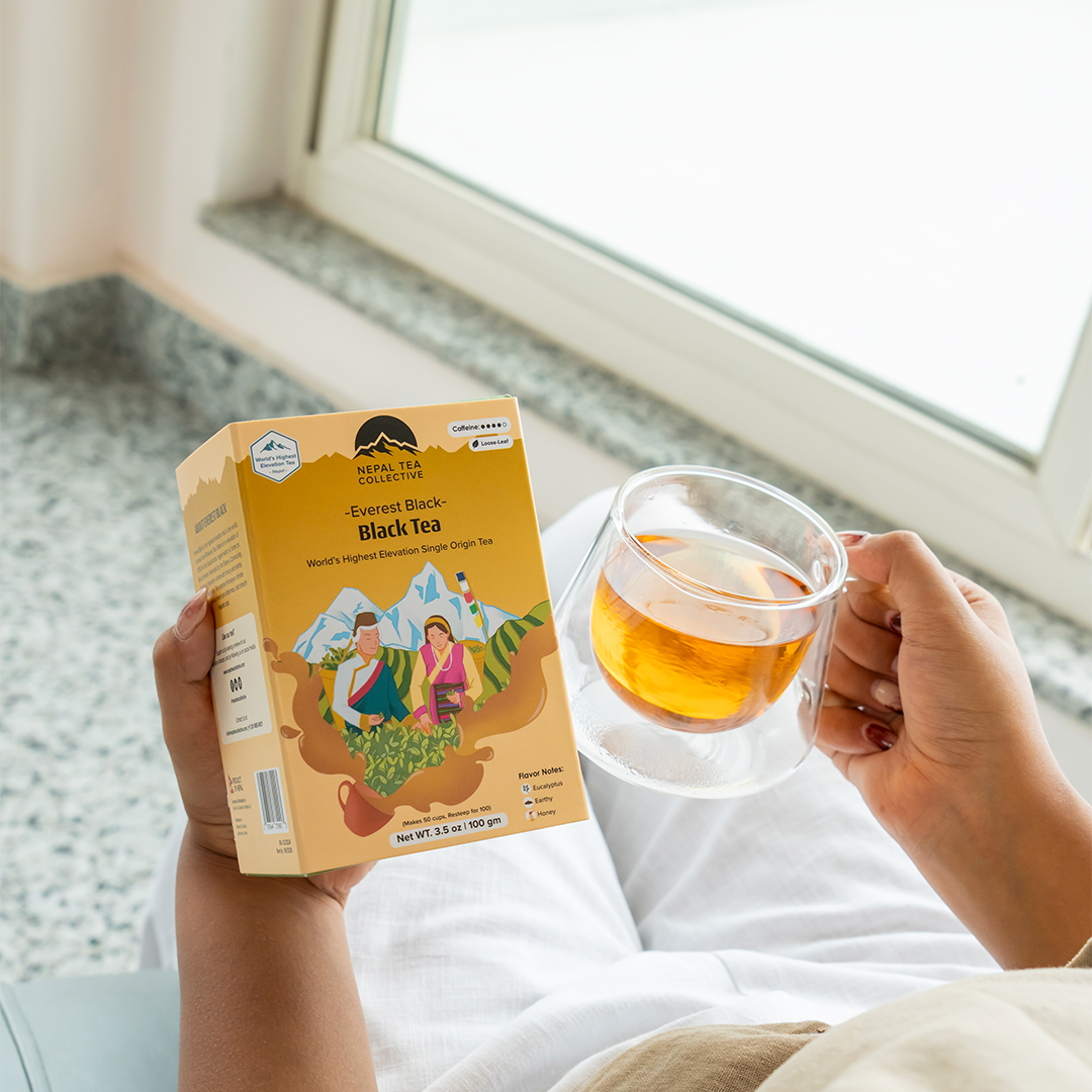 Nepal Tea Everest Black tea in a tea bag, showcasing dark black leaves and packaging with mountain imagery.