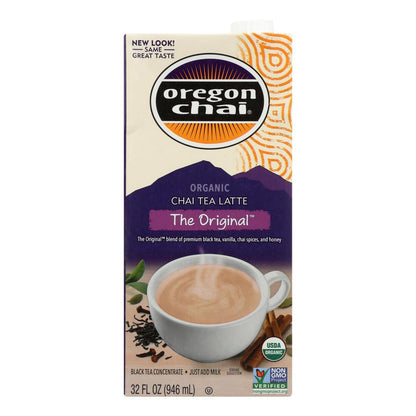 Oregon Chai Tea Latte Concentrate original flavor, 6-pack, 32 fl oz bottles, served in a glass with whipped cream and cinnamon.