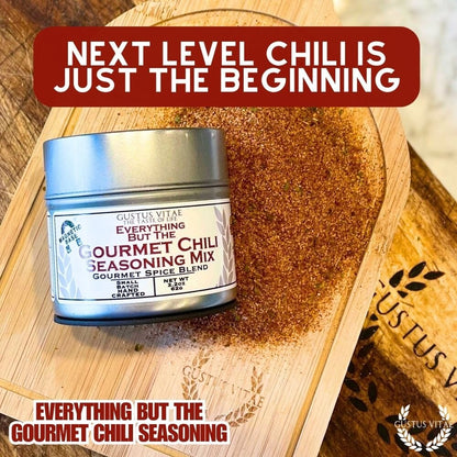 Gustus Vitae Everything But The Gourmet Chili Seasoning jar showing a colorful blend of spices in a glass container.