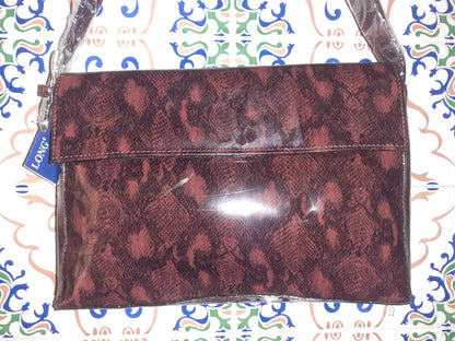Handmade women's shoulder bag with sturdy handles, featuring a unique crafted design and natural material finish.
