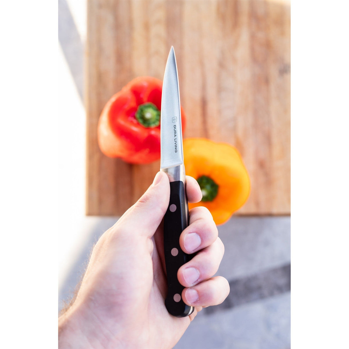 Dura Living Superior 3.5-inch black paring knife with stainless steel blade, perfect for precise kitchen peeling and slicing.