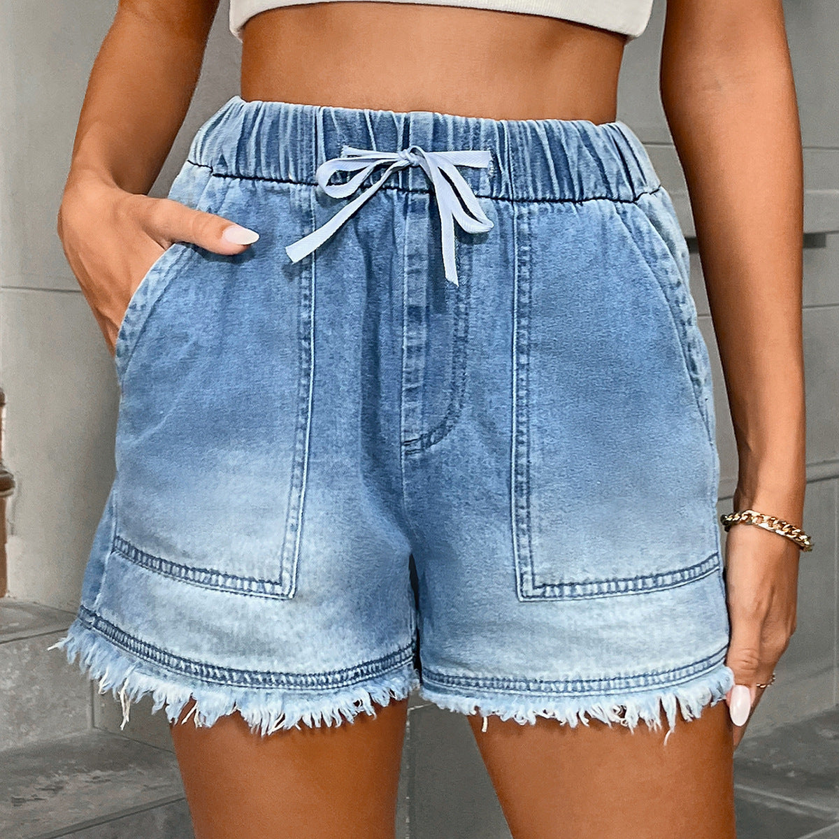 Women's denim shorts with elastic waist and drawstring waistband, front and back pockets