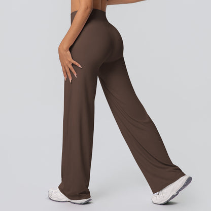 Casual high-waisted loose-fit solid-color yoga pants hugging the hips, front view
