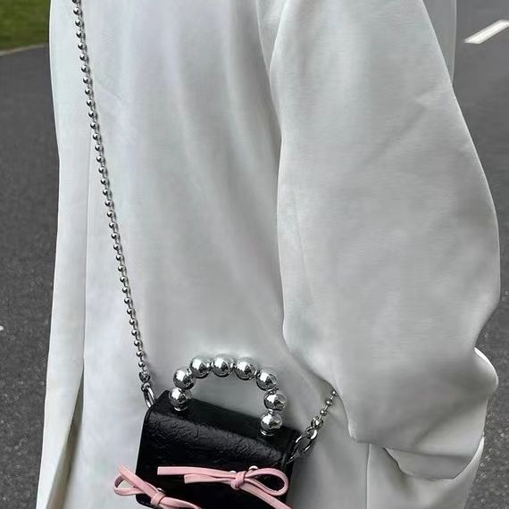 Textured cute bow mini chain handbag with compact design and decorative bow detail