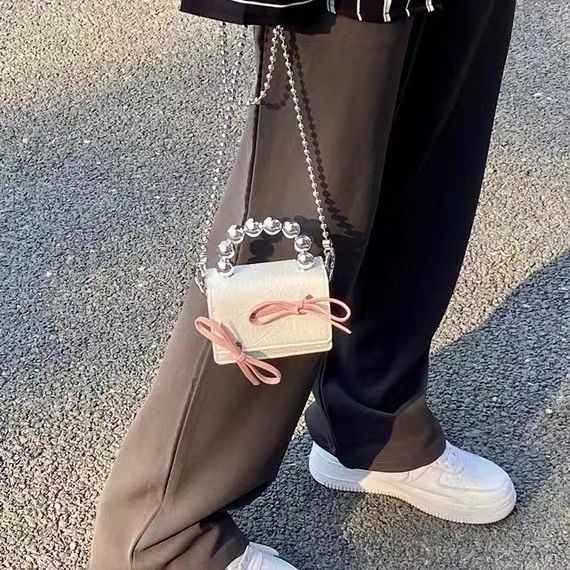 Textured cute bow mini chain handbag in a compact design with a decorative bow and chain strap