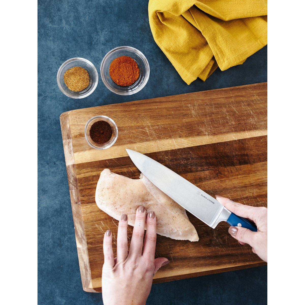Dura Living Superior 8-inch chef knife with a royal blue handle, sharp stainless steel blade for precise kitchen cutting.
