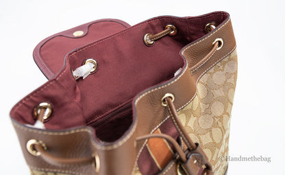 Coach Dempsey khaki saddle signature jacquard canvas patch backpack with adjustable straps and front pocket.