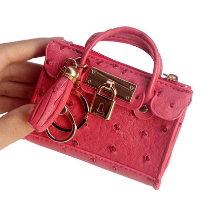 Leather solid color fashion tassel mini handbag with compact design and shoulder strap