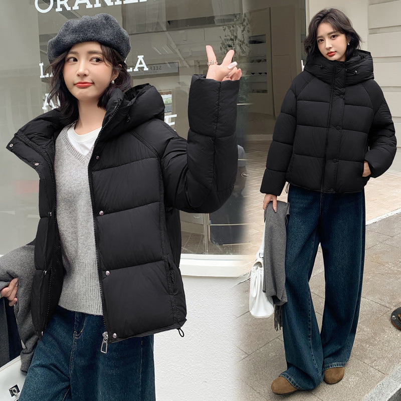 Women's stylish short down puffer coat in black with quilted panels and a stand collar