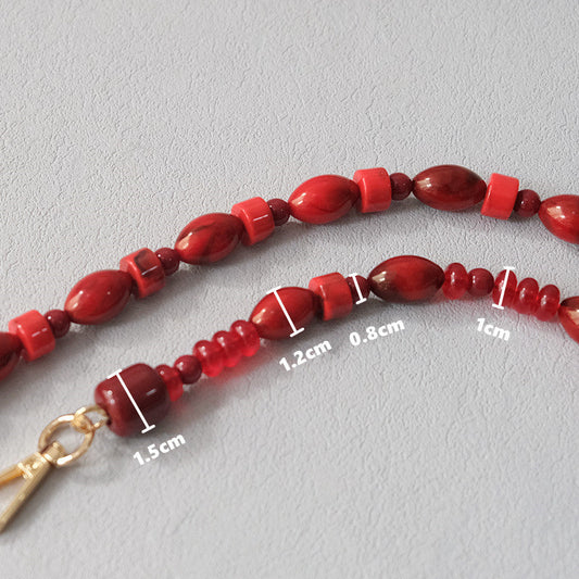 Red beaded chain crossbody lanyard bag accessory with a fashionable design