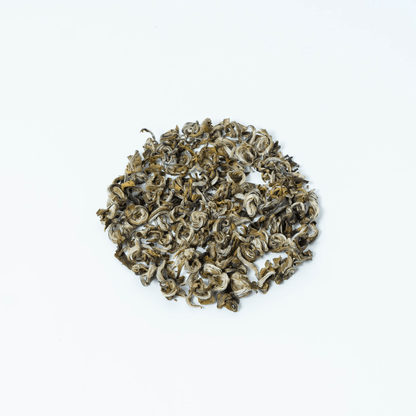 Organic Farmers' Green tea leaves from Nepal Tea, fresh green tea in a natural setting with farmers harvesting in the background.