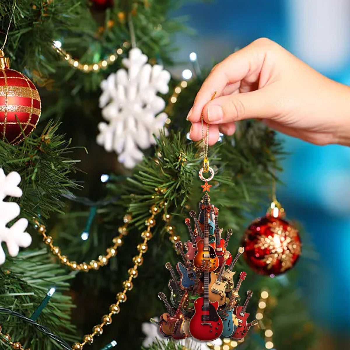 Guitar Christmas tree decorations featuring miniature guitar ornaments in festive holiday colors