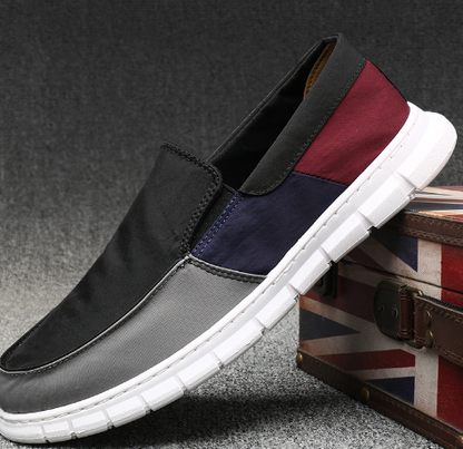 Men's color block slip-on canvas sneakers by BACKUPMYFILESNOW® with vibrant multi-colored panels and white rubber soles.
