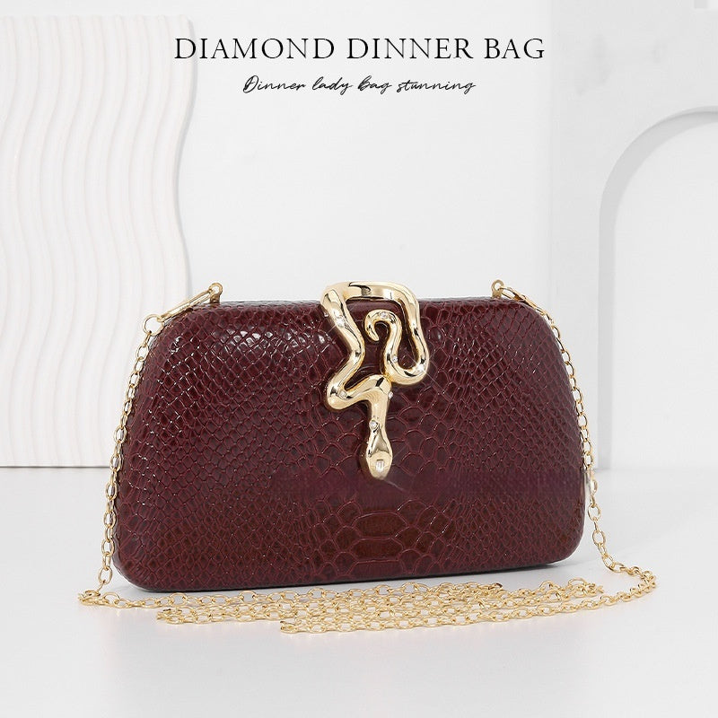 Women's snake-print evening tote with sophisticated European-American style, structured design and elegant top handles