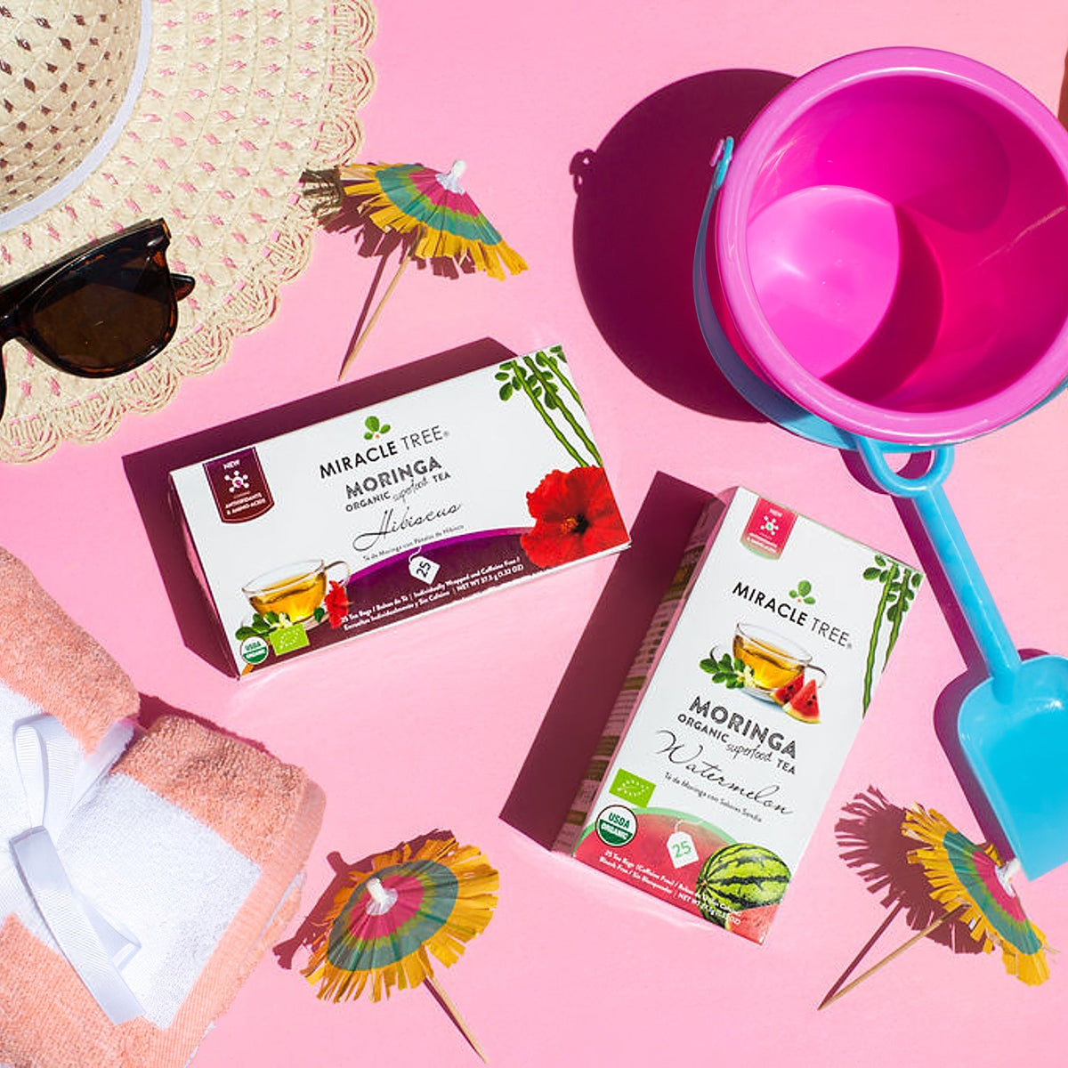 Organic Moringa and hibiscus herbal tea by Miracle Tree, featuring vibrant tea leaves in a natural setting.