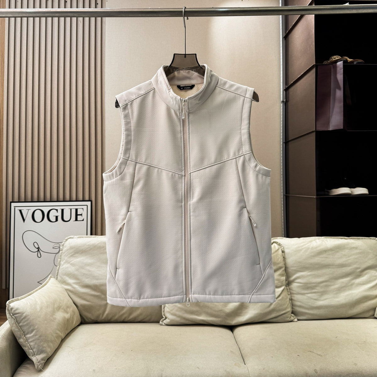 Men's and women's softshell vest with stand collar, zip-up front, fleece lining, and sleeveless windproof design