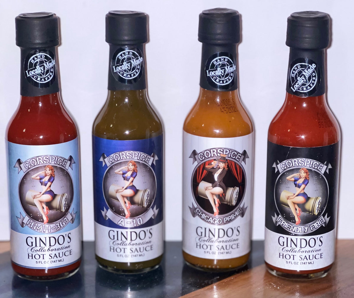 Four bottles of Corspice hot sauce in a 4-pack, featuring colorful labels and different flavors on each bottle.