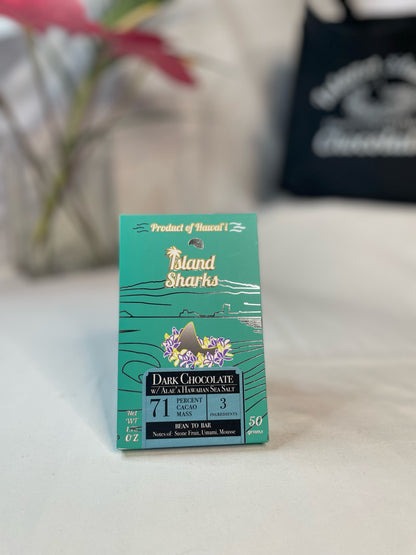 Six ISLAND SHARKS CHOCOLATE Hawai'i Inclusion Bars in assorted flavors, featuring colorful packaging and bars with tropical ingredients.