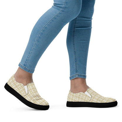 White women's slip-on shoes by Atelier Evezet Arapakou with waterproof canvas and anatomical sole, shown from a side angle.