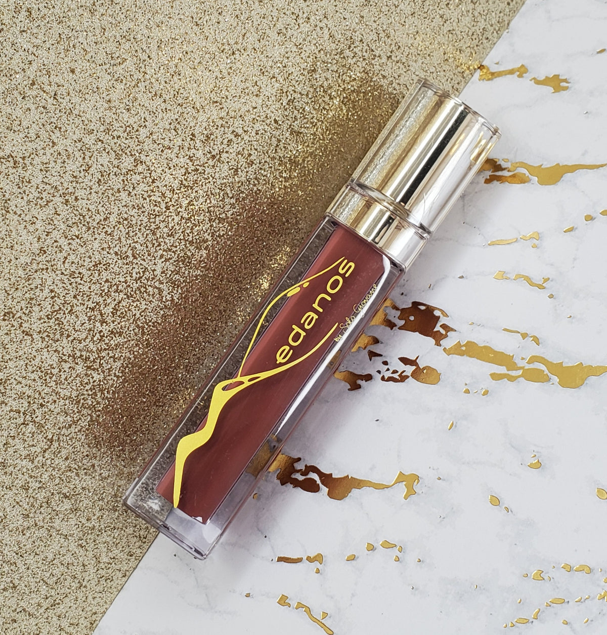 Medanos Lipgloss Collection #11 by BACKUPMYFILESNOW® featuring glossy lip glosses in various shades and sleek packaging.