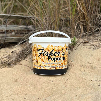 Fisher’s Popcorn caramel popcorn tub, 1.2-gallon size, featuring a sturdy container with fresh caramel popcorn inside.