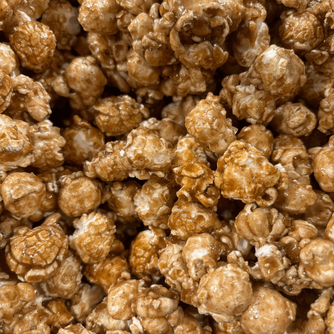 Fisher's Popcorn caramel popcorn tub, 1.2-gallon size, in a large Fisher's Popcorn branded popcorn tub.