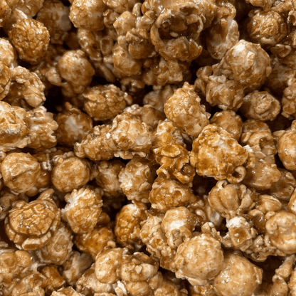 Fisher's Popcorn caramel popcorn tub, 1.2-gallon size, in a large Fisher's Popcorn branded popcorn tub.