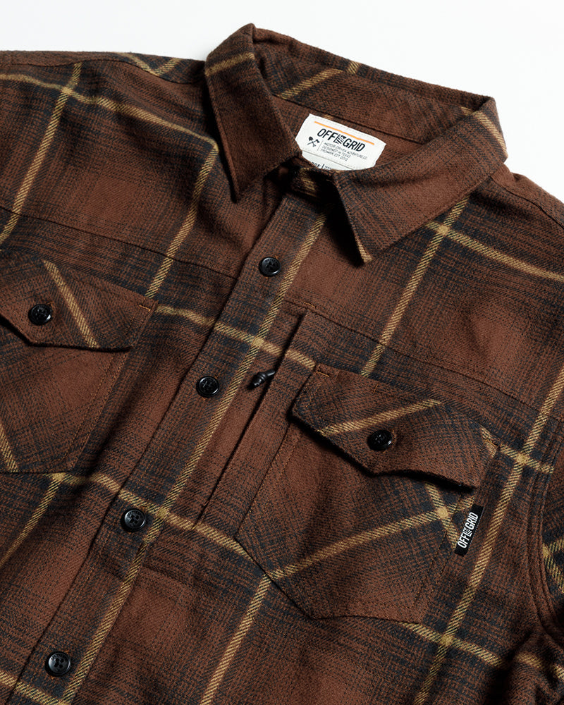 Burnt brown Off The Grid Surplus Destroyer Flannel shirt displayed on a hanger, showcasing its cozy, plaid design.