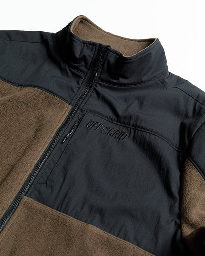 Brown Bruin Fleece Zip Up by Off The Grid Surplus, shown in a close-up image highlighting the fleece fabric and zipper detail.