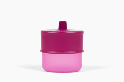 Flipping Holder KiddyTrek 4-in-1 nursing and feeding set with raspberry food pouch, juice box holder, snack cup, and sip cup.