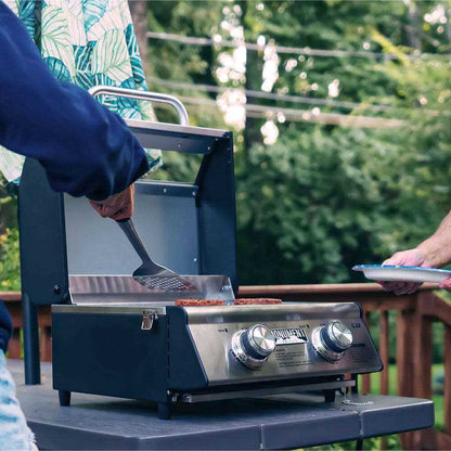 Stainless G22 Monument Grills tabletop propane gas grill with cooking surface and control knobs, perfect for outdoor grilling.
